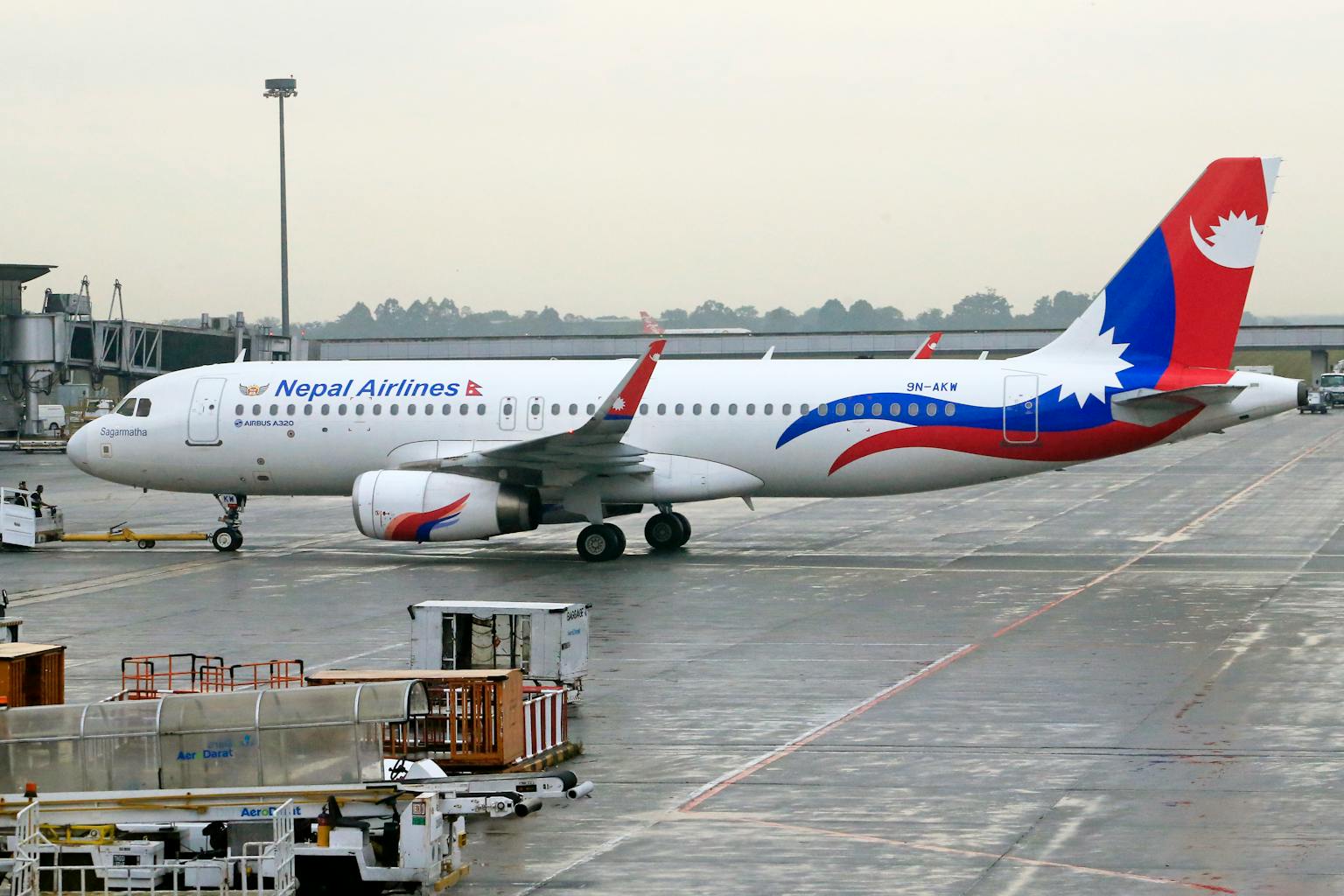 Nepal Airlines Airbus A320 stationed on airport runway, ready for departure.