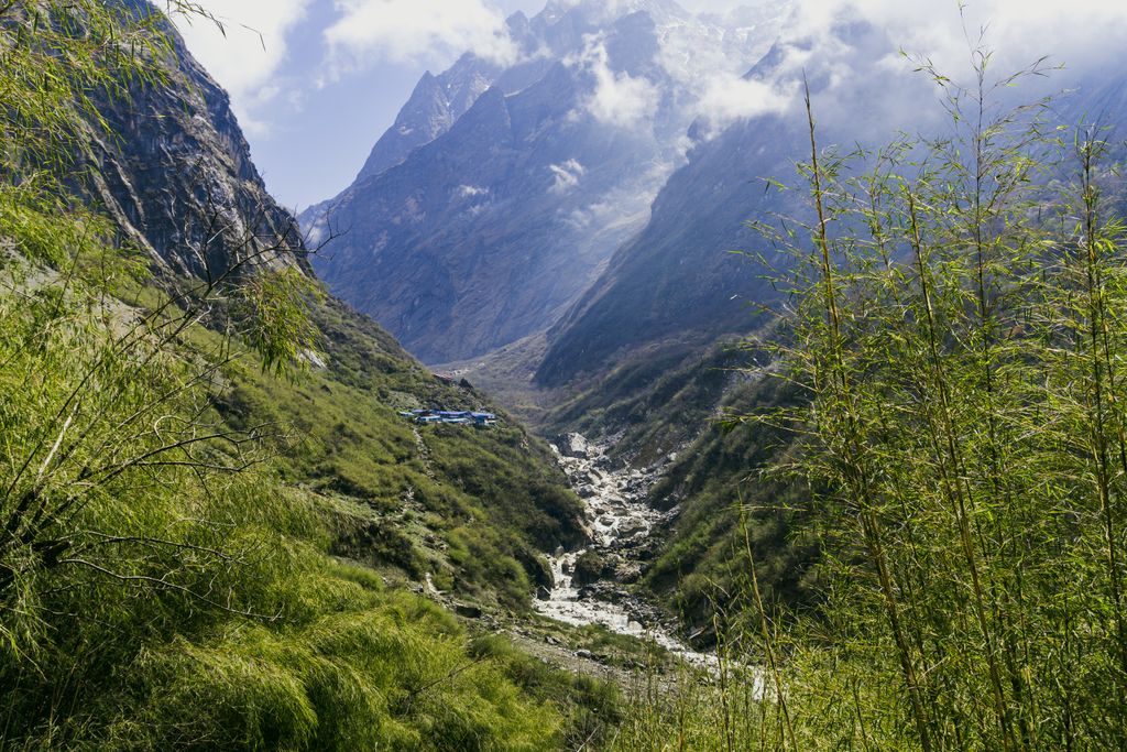 Explore the breathtaking Annapurna landscape with towering mountains and lush greenery.